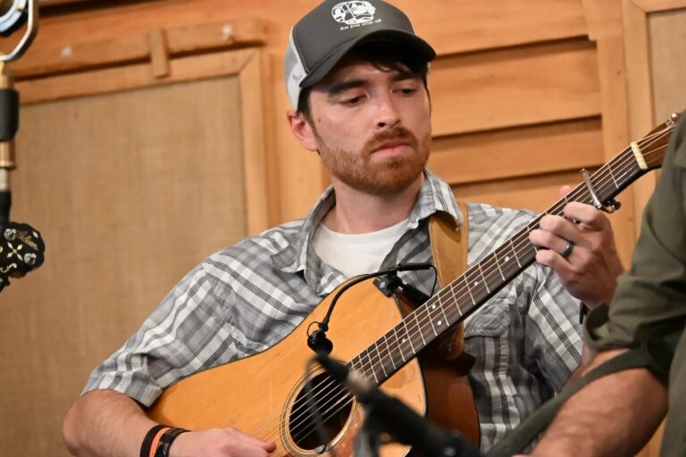 Justin Jones with his Martin dreadnought guitar